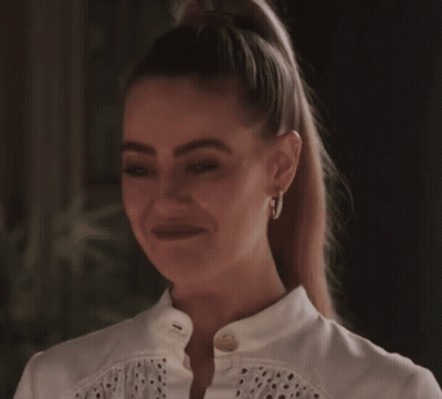 Woman Smiling With Hoop Earrings And Ponytail GIF