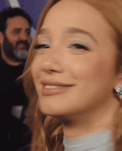 Woman Smiling With Man In Background GIF
