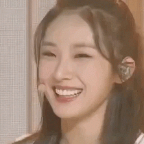 Woman Smiling With Microphone In Ear GIF