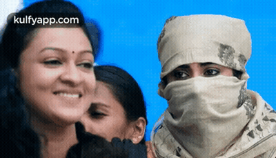 Woman Smiling With Scarf Next To Two Women GIF