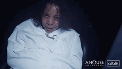 Woman Smirking In Straight Jacket GIF