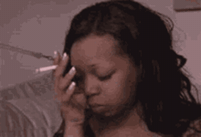 Woman Smoking Cigarette And Holding Head GIF