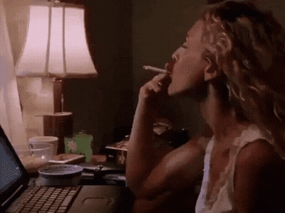 Woman Smoking Cigarette At Laptop GIF