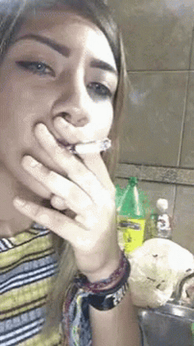 Woman Smoking Cigarette At Sink GIF