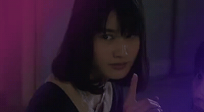 Woman Smoking Cigarette Covering Mouth In Dark Room GIF