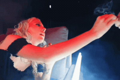 Woman Smoking Cigarette In Dark Room With Red Light GIF