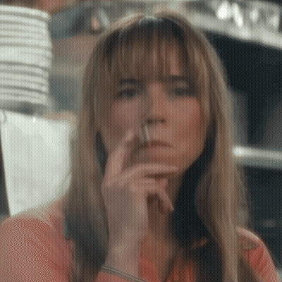 Woman Smoking Cigarette Looking At Camera GIF