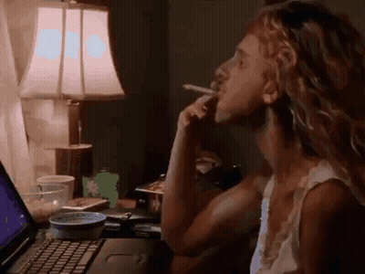 Woman Smoking Cigarette Looking At Laptop GIF