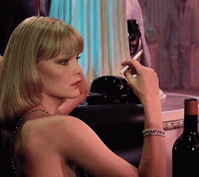 Woman Smoking Cigarette Next To Wine GIF