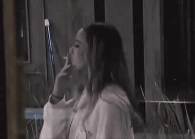 Woman Smoking Cigarette on Bench