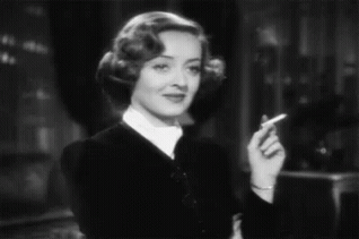 Woman Smoking Cigarette Smiling Black And White GIF