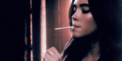 Woman Smoking Cigarette With Eyes Closed GIF