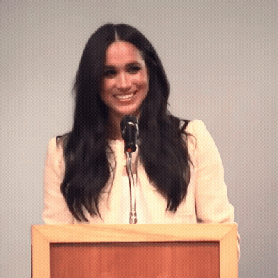 Woman Speaking Into Microphone At Podium GIF