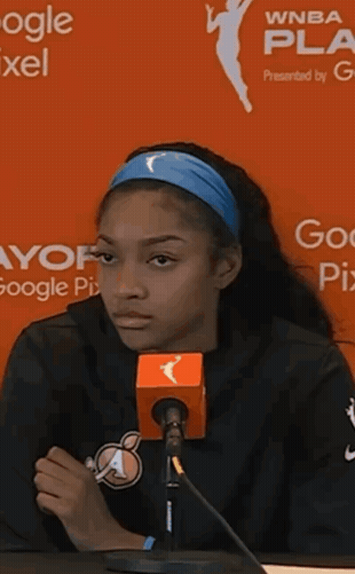 Woman Speaking Into Microphone In Front Of WNBA Sign GIF