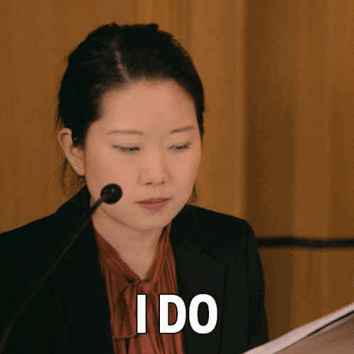 Woman Speaking Into Microphone With I Do Above Her Head GIF