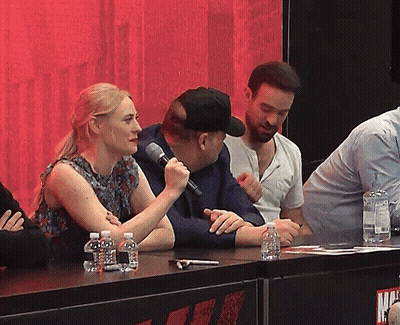 Woman Speaking Into Microphone With Water Bottles GIF