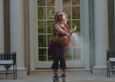 Woman Spraying Water From Hose GIF