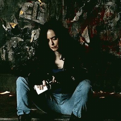 Woman Squatting Next To Bottle Of Liquor GIF