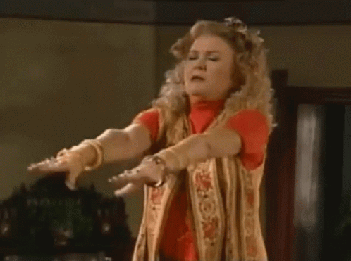 Woman Standing Arms Outstretched Making Funny Face GIF