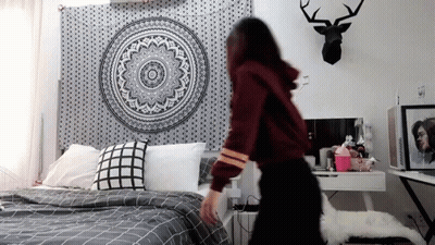 Woman Standing Before Bed With Mandala Tapestry GIF