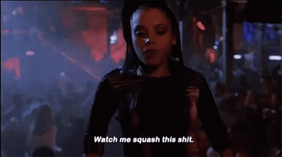 Woman Standing Before Crowd In Dark Room GIF