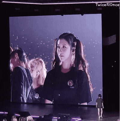 Woman Standing Before Twice Screen GIF