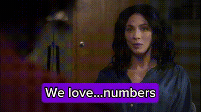 Woman Standing Before We Love Numbers Sign GIF