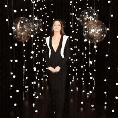 Woman Standing By Balloons And Lights GIF