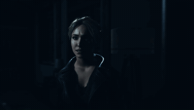 Woman Standing In Dark Room Looking Out Doorway GIF