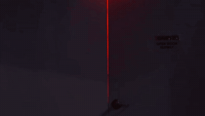 Woman Standing In Dark Room With Red Light GIF