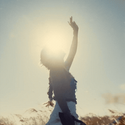 Woman Standing In Field With Arms Outstretched GIF