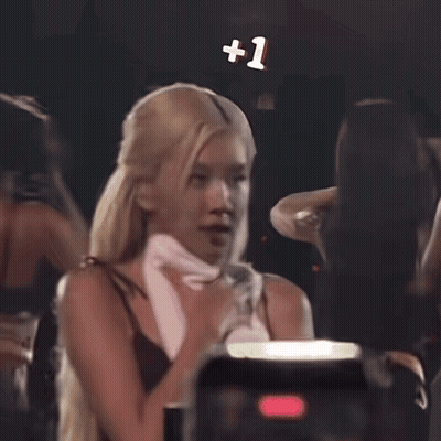 Woman Standing In Front Of +1 Sign GIF