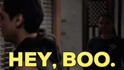 Woman Standing In Front Of American Flag Saying Hey Boo GIF