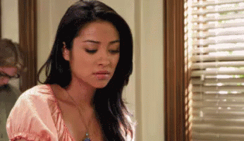 Woman Standing In Front Of Blinds GIF