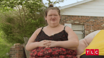 Woman Standing In Front Of Brick House With TLC GIF