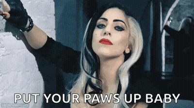 Woman Standing In Front Of Brick Wall With Arms Outstretched GIF