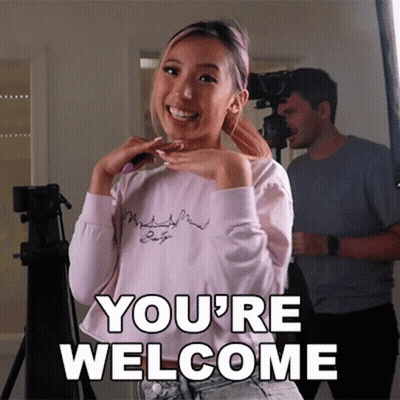 Woman Standing In Front Of Camera Saying You're Welcome GIF
