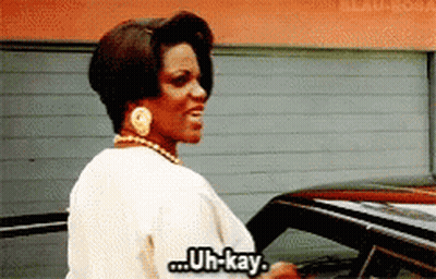 Woman Standing In Front Of Car Says Uh-Kay GIF