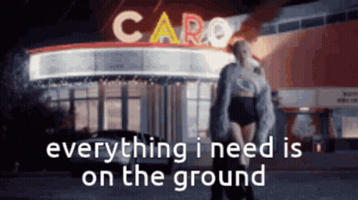 Woman Standing In Front Of Caro Building GIF