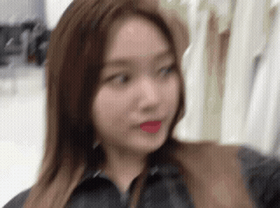 Woman Standing In Front Of Clothes GIF