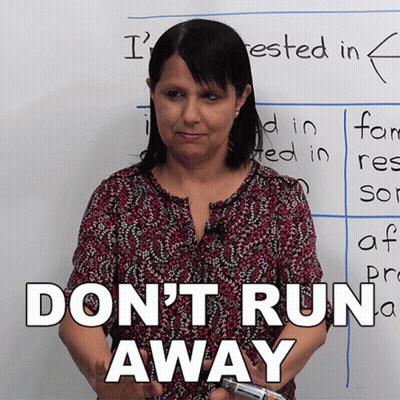 Woman Standing In Front Of Do Not Run Away Whiteboard GIF