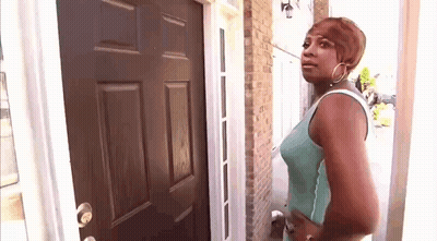 Woman Standing In Front Of Door Looking At It GIF