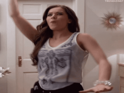 Woman Standing In Front Of Door With Arms In Air GIF