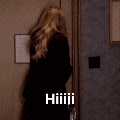 Woman Standing In Front Of Door With Hiiiiii GIF