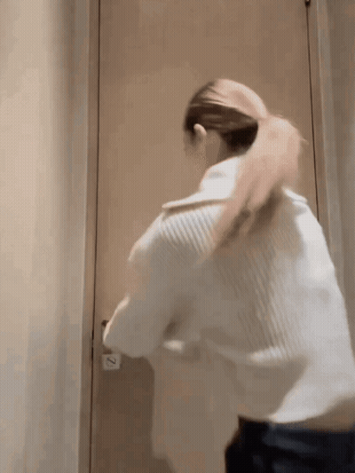 Woman Standing In Front Of Door With Number 2 GIF