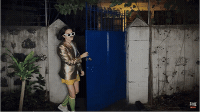 Woman Standing In Front Of Fame Gate GIF