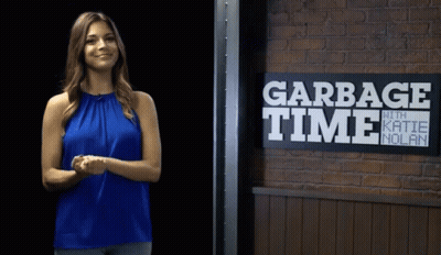 Woman Standing In Front Of Garbage Time Sign GIF