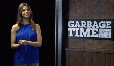 Woman Standing In Front Of Garbage Time Sign GIF