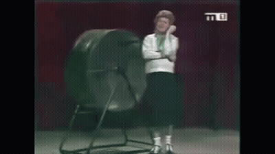 Woman Standing In Front Of Giant Wheel GIF