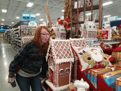 Woman Standing In Front Of Gingerbread House GIF